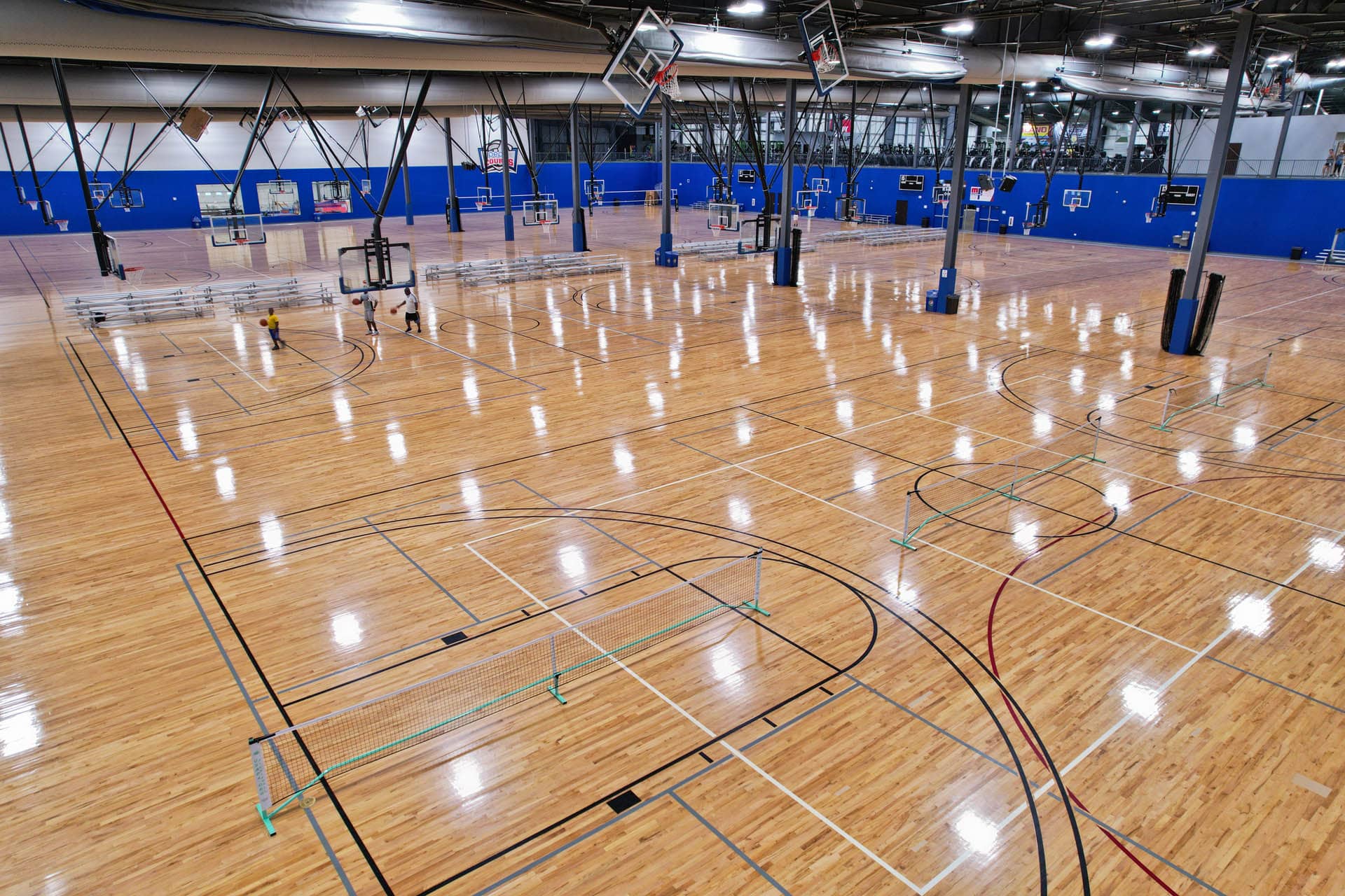 Empty series of indoor basketball and/or volleyball courts.