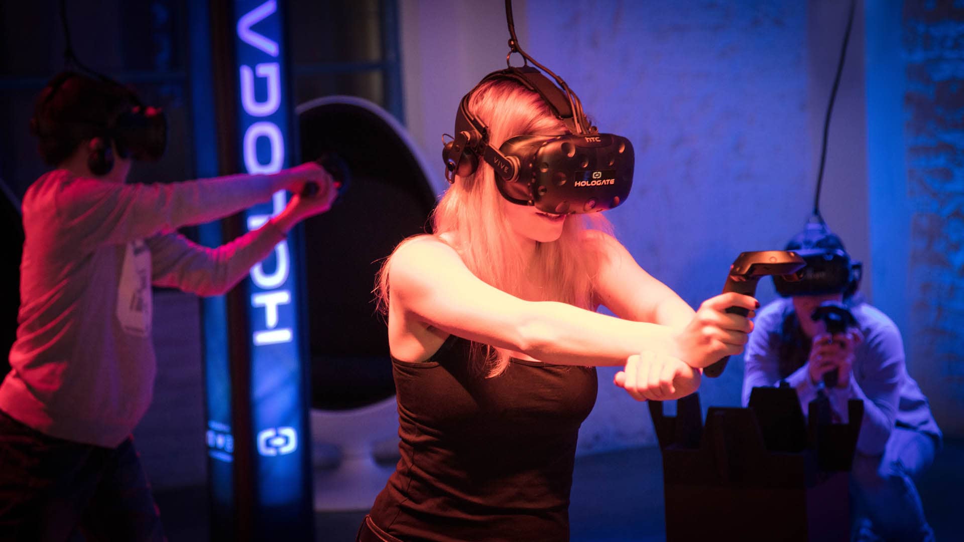 Girl in a VR headset pointing a controller in the HoloGate.