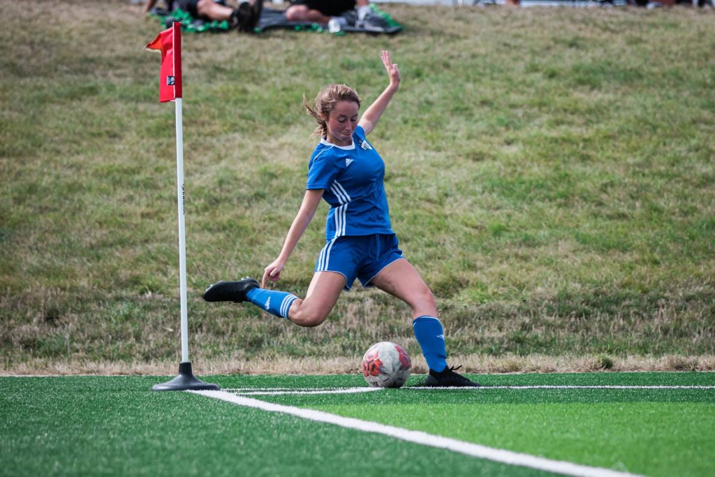 Girl winding up for a corner kick in soccer.