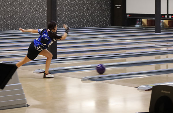 woman in blue league jersey bowling
